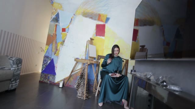 Model With Grapes Sitting In A Chair