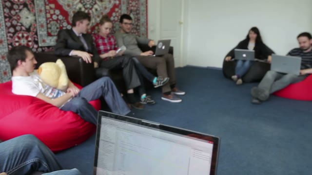 Smiling Creative Team With Laptop Computers