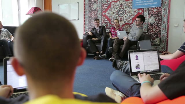 Smiling Creative Team With Laptop Computers