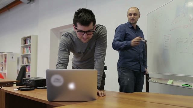 Two Man Draw Diagrams On The White Board And Discuss
