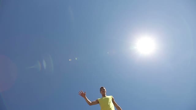 Two Smiling Men On Stilts Step Over The Camera