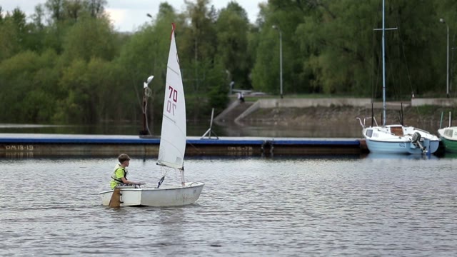Boy Sets Sail On A Boat With A Sail