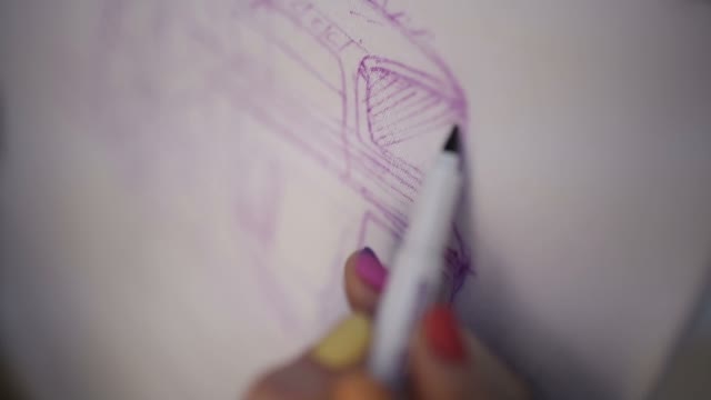 The Woman Draws A Car On Fabric With Markers
