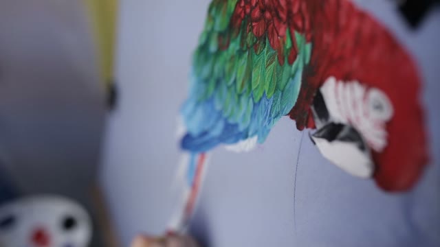 Hand With A Brush Paints A Parrot