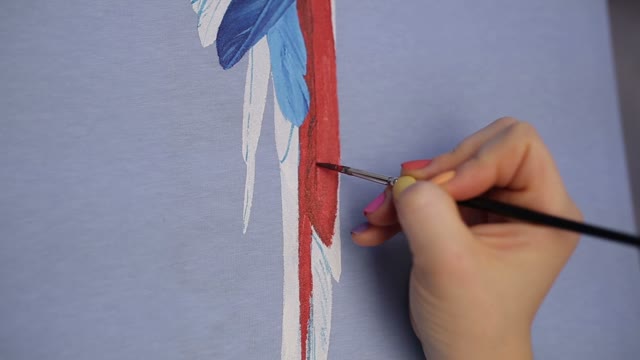 Hand With A Brush Paints A Parrot