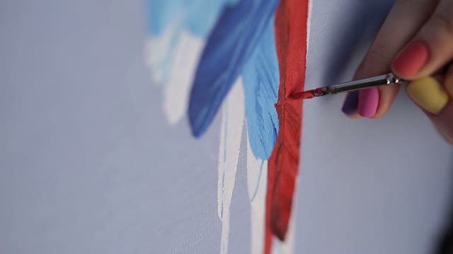 Hand With A Brush Paints A Parrot