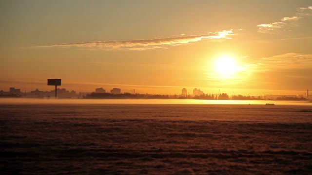 Sunrise. Field. City Distance
