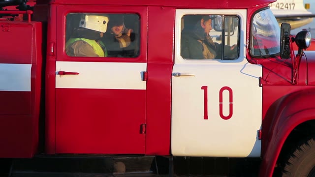 Firefighters In A Fire Engine. Close-up