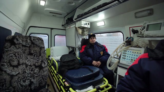 Woman Medic In The Ambulance