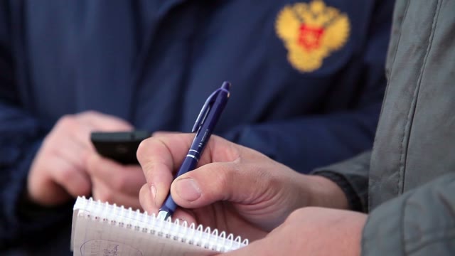 The Man Writes In A Notebook. Close-up