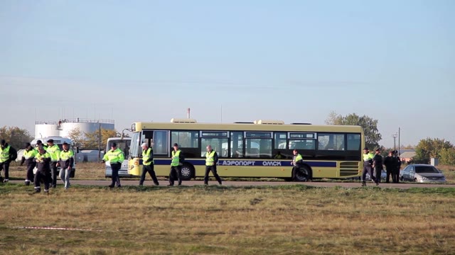 Workers Go On The Field. The Bus Arrives