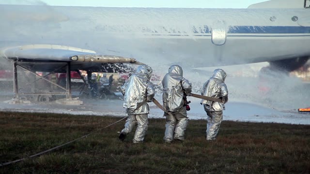 The Team Fireproof Suits With Fire Hose