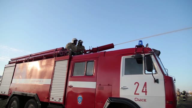 Firemen Using Water Cannon To Fight Fire