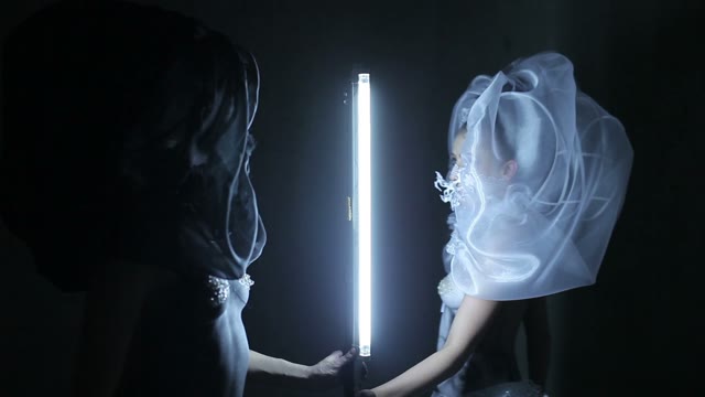 Two Body Art Models Go Around The Lamp