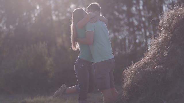 Couple In Love Hugging And Falls In A Haystack