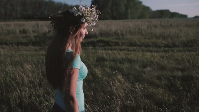 Smiling Woman With A Wreath On His Head Walking Through The Meadow