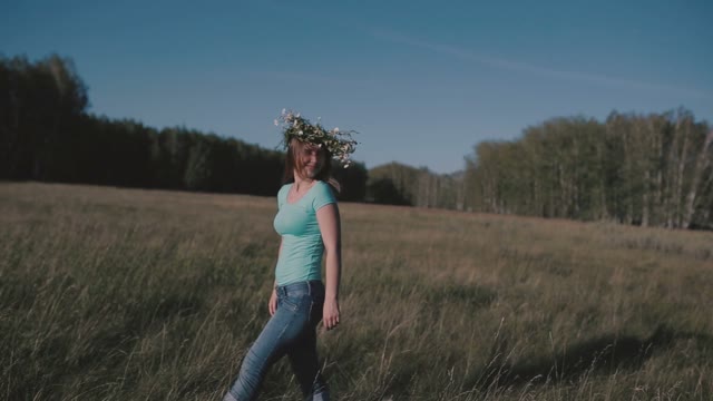 Girl With A Wreath Walking Through The Meadow