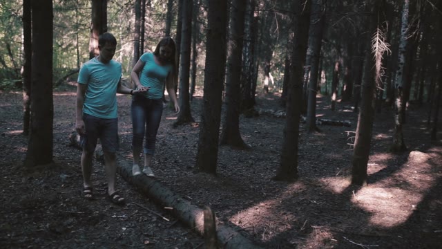 Girl Walking On Fallen Tree, Holding Her Man