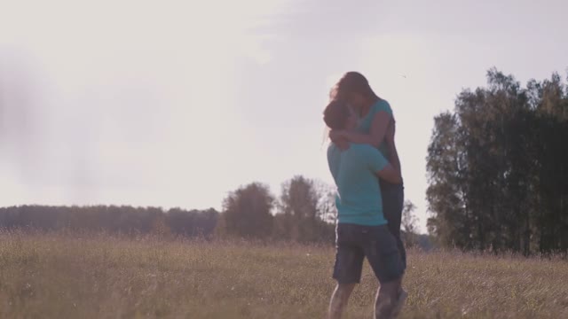 The Guy Holding The Girl In His Arms In Nature