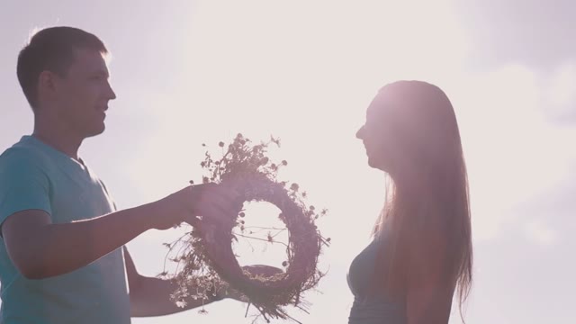The Man Wears A Wreath And Flowers At The Girl