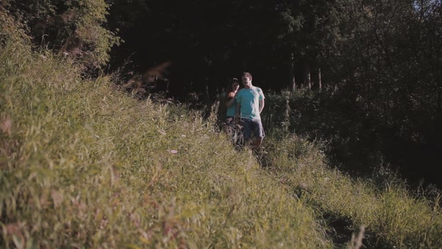 Happy Couple Walking In Forest Hill
