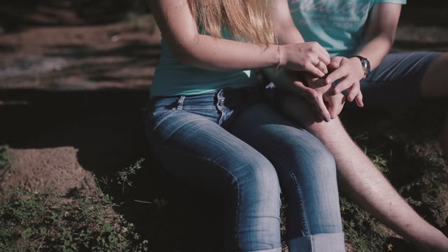 Close-up Image Of A Young Couple Holding Hands
