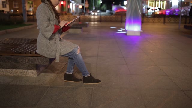 A Young Woman In The Square And Using Digital Tablet.