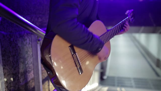 Close-up Guitar. Man Playing In The Underground Passage