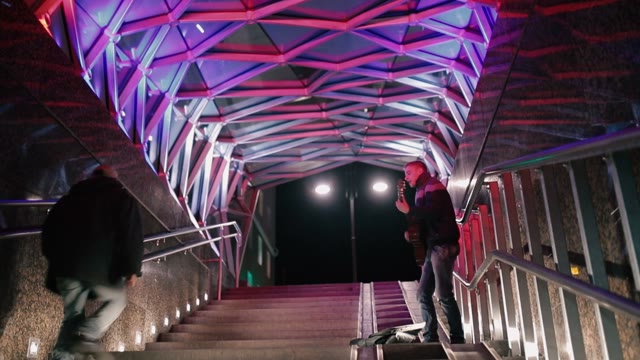 A Young Man Plays Guitar And Sings In The Underpass