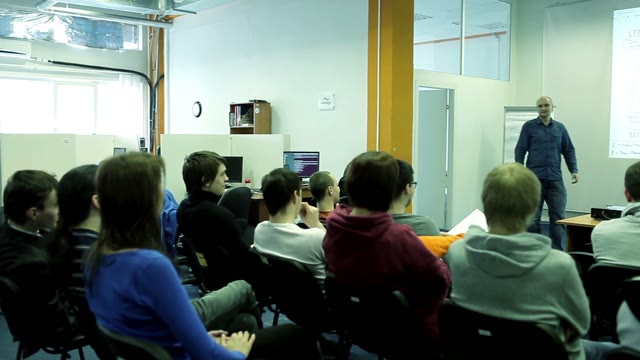 The Speaker Tells Something To A Small Group In The Room
