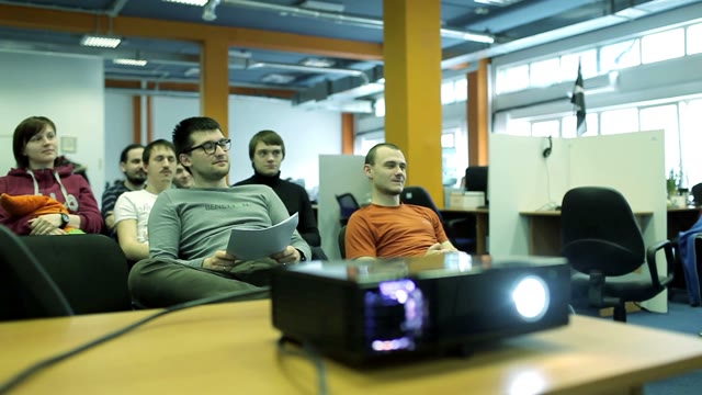 A Small Group Of Students Sitting On Chairs In A Small Audience And Raise Their