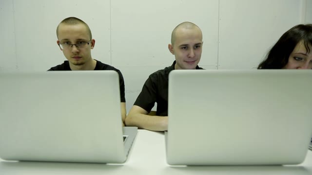 Smiling Young Man And Woman Working On The Computer
