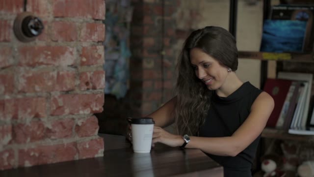 Beautiful Smiling Woman At A Table In A Cafe