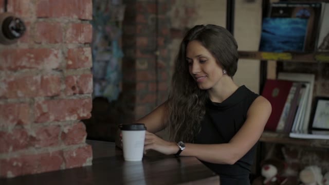 A Woman Looking At Phone And Smiling At The Restaurant