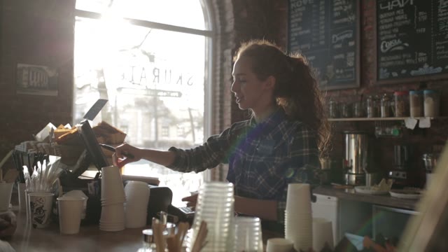 Beautiful Girl Behind The Counter At The Coffee Shop Write The Name Of The Cup
