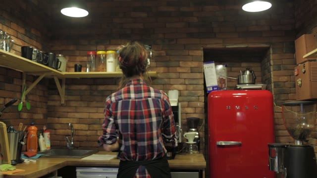 Beautiful Young Girl In The Kitchen In A Cafe Preparing Food