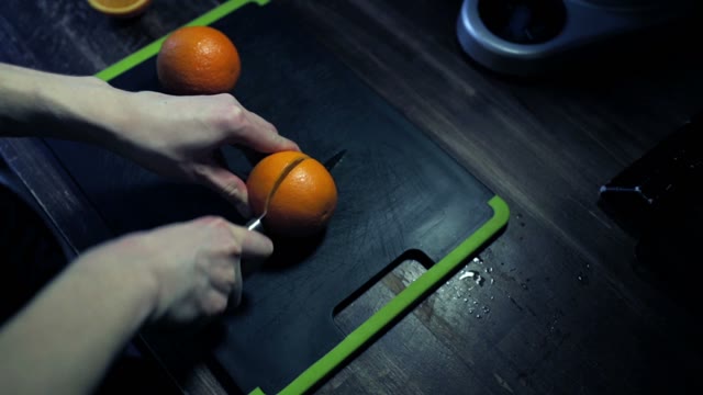 Sliced Ripe Oranges On A Black Cutting Board