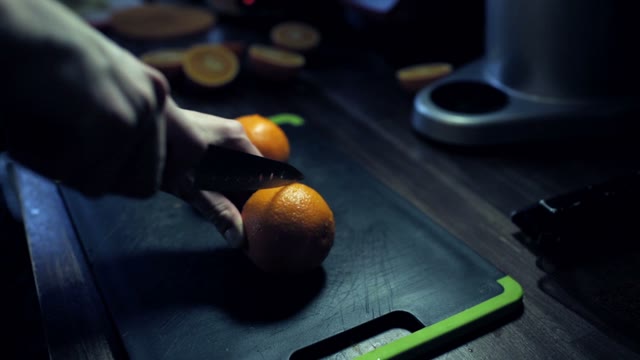 Ripe Juicy Oranges Cut In Half On A Black Cutting Board