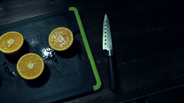 Cutting In Half Juicy Oranges On A Cutting Board