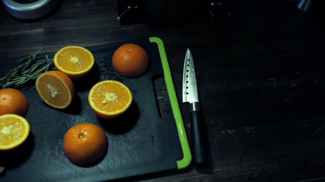 Cut In Half Juicy Oranges, Greens And Cinnamon On A Cutting Board