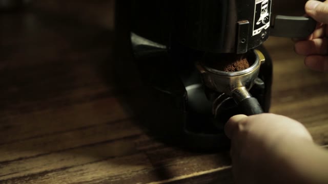 Bartender Grinding Coffee For Espresso In Restaurant