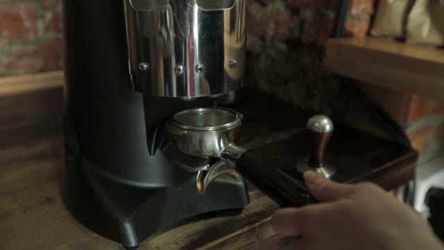 Bartender Grinding Coffee For Espresso In Restaurant