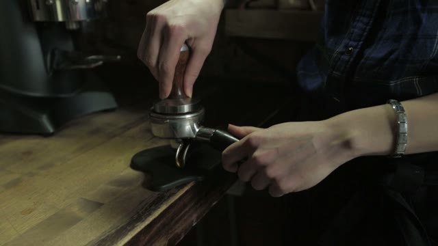 Barista Tamping The Grind Coffee For Espresso, Close-up