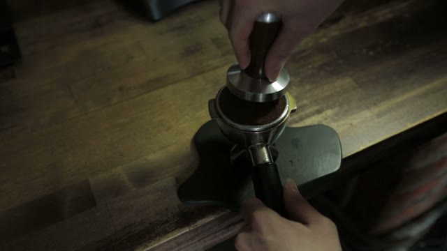 Barista Tamping The Grind Coffee, Close-up