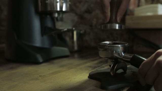 Barista Tamping The Grind Coffee For Espresso