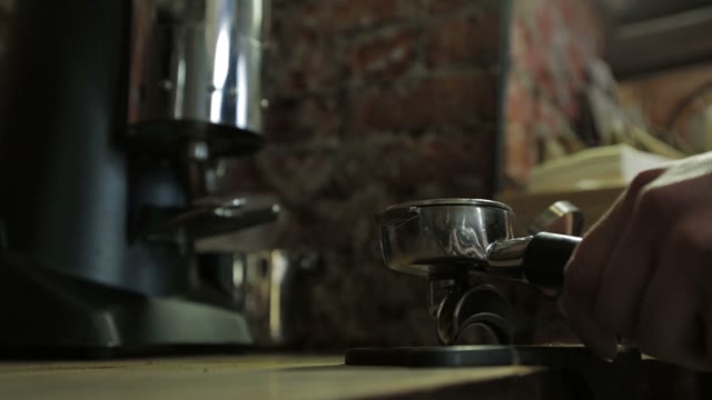 Barista Tamping The Grind Coffee For Espresso