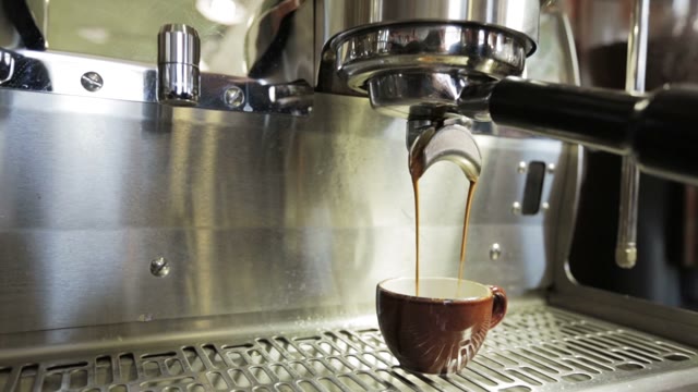 Machine Brewing Espresso Into Cup