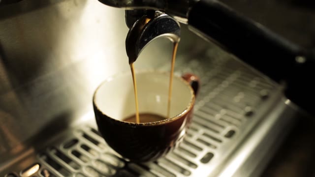 Machine Brewing Espresso Into Cup