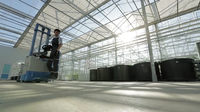 Forklift With Boxes Rides By And Large Hangar