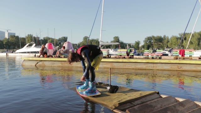 Wakeboarder Lacing Protection Shoes Preparing To Start Action